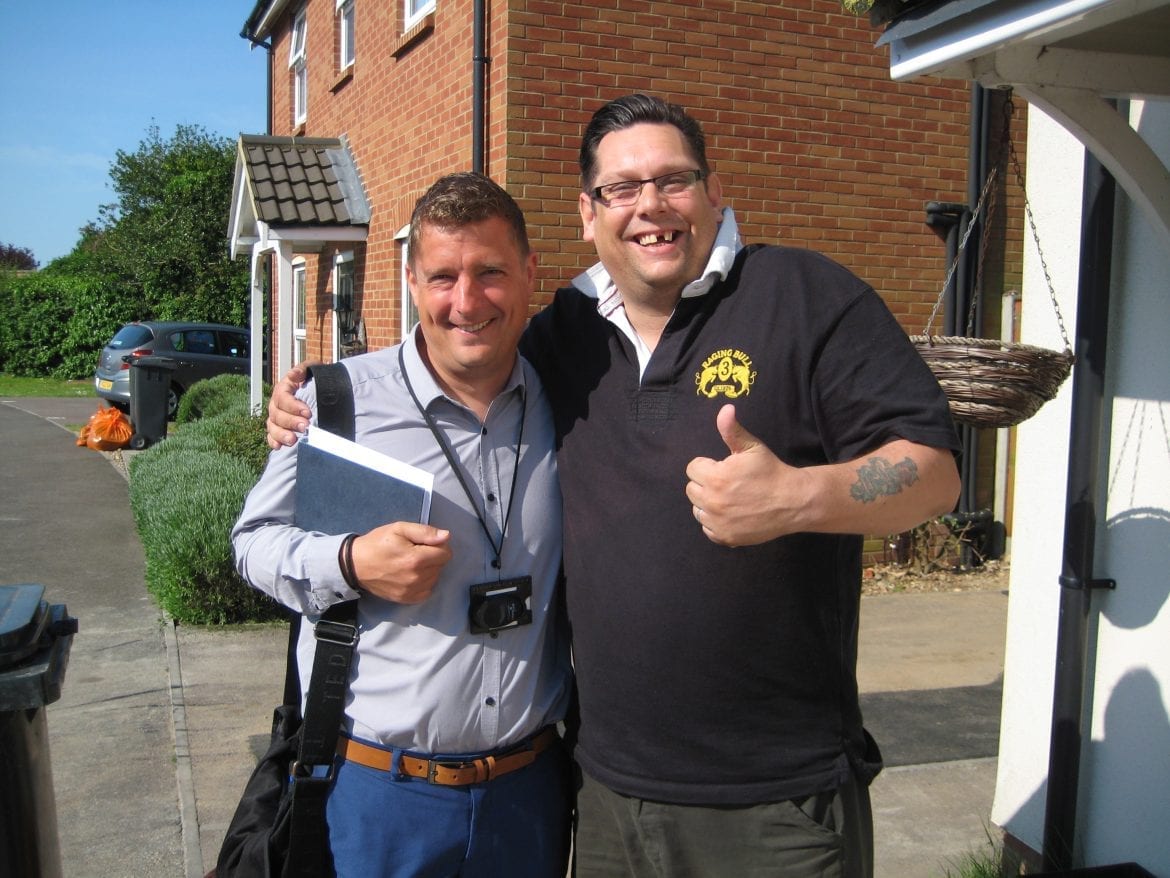 Kensa Ground Source Heat Pump Review: Social Housing - (L) Matt Smith (Flagship) and (R) Mr Streater (tenant) outside the flats and house which share a Kensa micro ground source heat network.