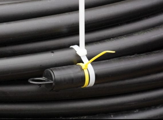 Ground source heat pump coiled slinky pipe - yellow