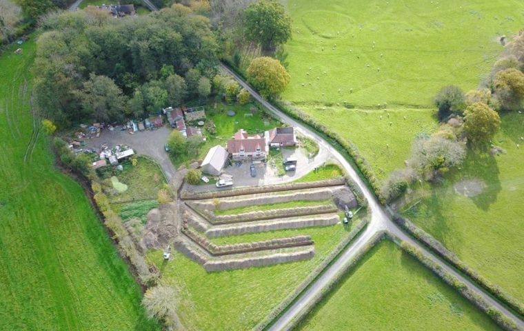 Brick Cottage ground source heat pump case study: aerial view completed slinky trenches from afar