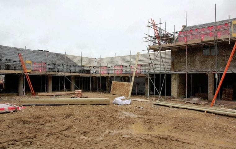 Bibury Farm Barns ground source heat pump case study: external scaffolding during renovation