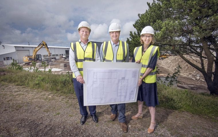 MP Sarah Newton, Simon Lomax (Kensa’s CEO) and Craig Pascoe (HSBC) pose with architect’s plans at the site of Kensa’s new factory build. Photograph by Emily Whitfield-Wicks