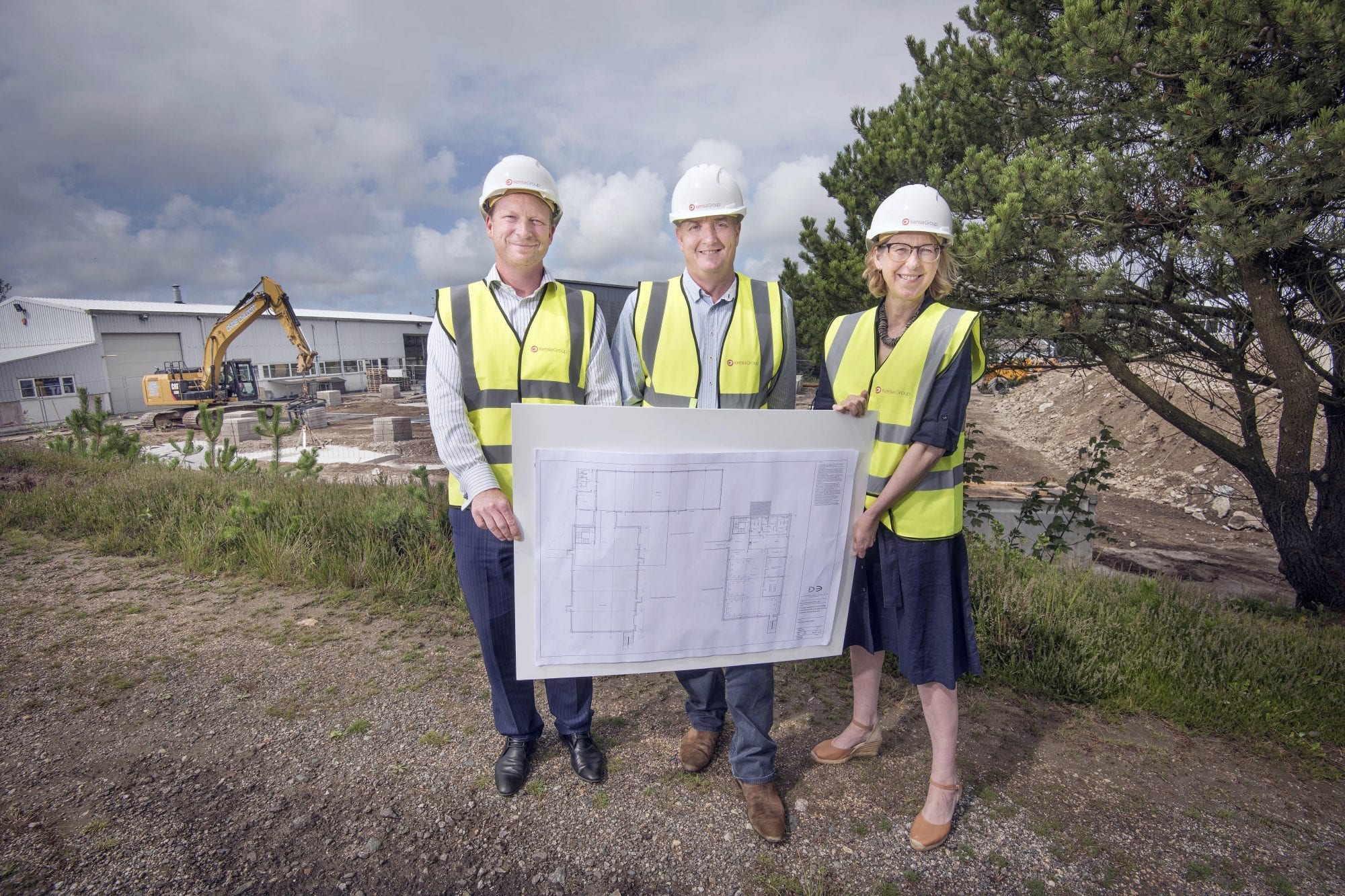 MP Sarah Newton, Simon Lomax (Kensa’s CEO) and Craig Pascoe (HSBC) pose with architect’s plans at the site of Kensa’s new factory build. Photograph by Emily Whitfield-Wicks